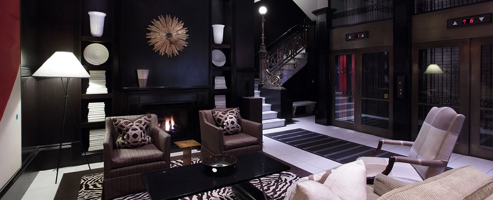 Hotel lobby featuring some special commission art pieces, gas fireplace, and seating for up to five guests.