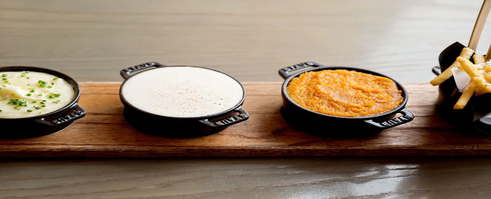 Food Sampling Photograph of our Truffle Fries with three sides to accompany the meal.