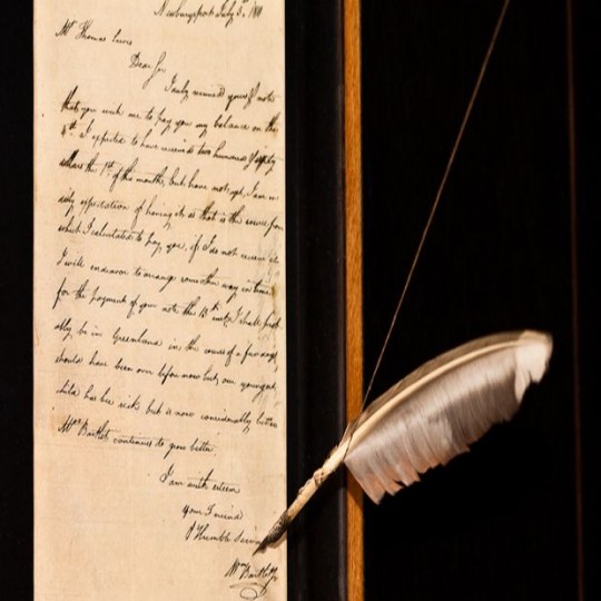 Historic piece of art that is showcased in a letter format with a feather pen