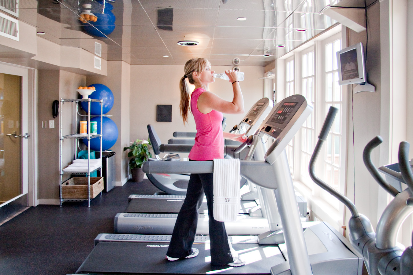 Photograph if a beautiful woman working out on our treadmil machine in our 24/7 fitness center.
