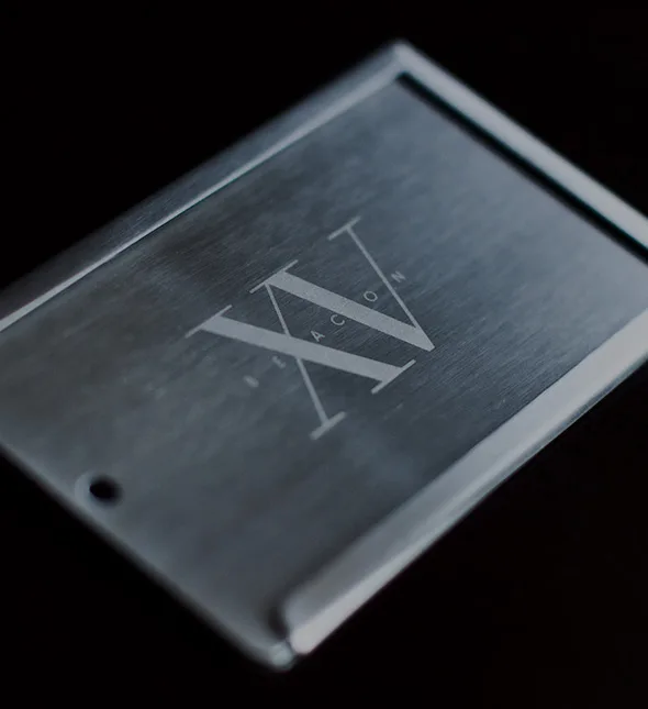 Fifteen beacon business card holder with the hotel's logo in the middle.