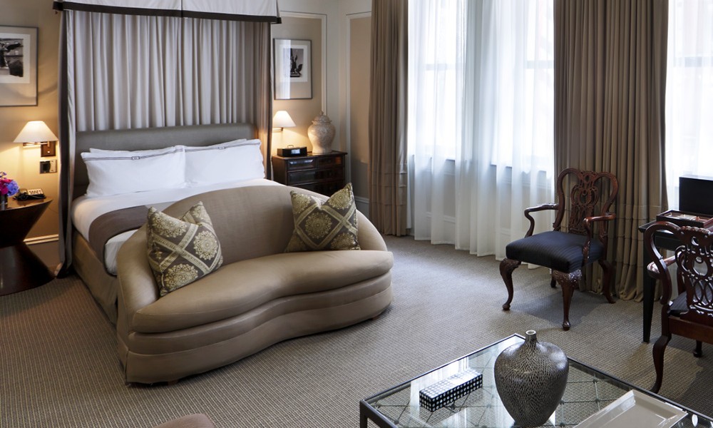 Beacon Hill Studio Room - Approximately 485 square feet with a luxurious sitting area and views of historic Beacon Street. In front of the fireplace – a love seat or two comfortable arm chairs with an ottoman, a 42