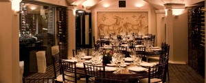 The Wine Cellar, our historic private dining room boasts a renovated Italian Mosaic from 500 AD, double vaulted ceilings that are highlighted by hundreds of bottles of wine that dramatically line the space. The Wine Cellar comfortably accommodates 35 guests with existing chairs, and up to 50 guests with rented chivari chairs. As The Wine Cellar is rectangular, we are unable to accommodate a U-shape, although we can seat up to 28 guests at one long table.