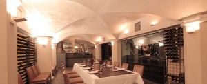 Wine Cellar with our 400 plus wines showcased on the interior of the wine cellars walls. Dinner table in the middle with seating for 8 people.