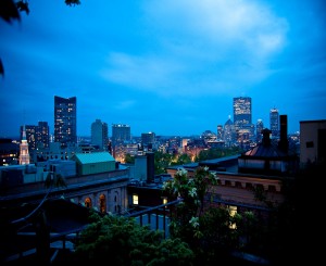 Fifteen Beacon's view from our roof deck overlooking Boston's building after dark.
