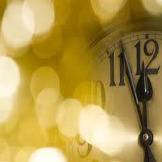 old black and white clock that reads midnight for New Years Eve