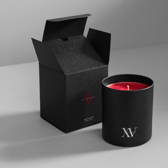 sleek black fifteen beacon candle that showcases our signature scent in the lobby of the hotel.