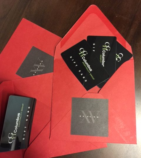 Red Fifteen Beacon envelopes with gift cards from Columbus Hospitality Group