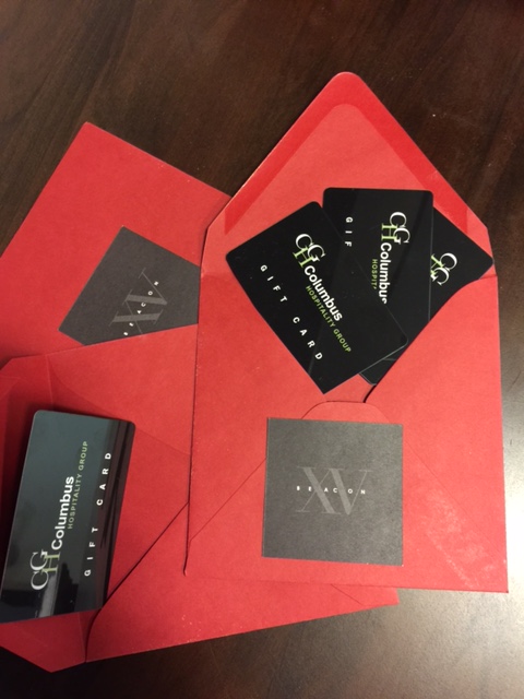 Red Fifteen Beacon envelopes with gift cards from Columbus Hospitality Group