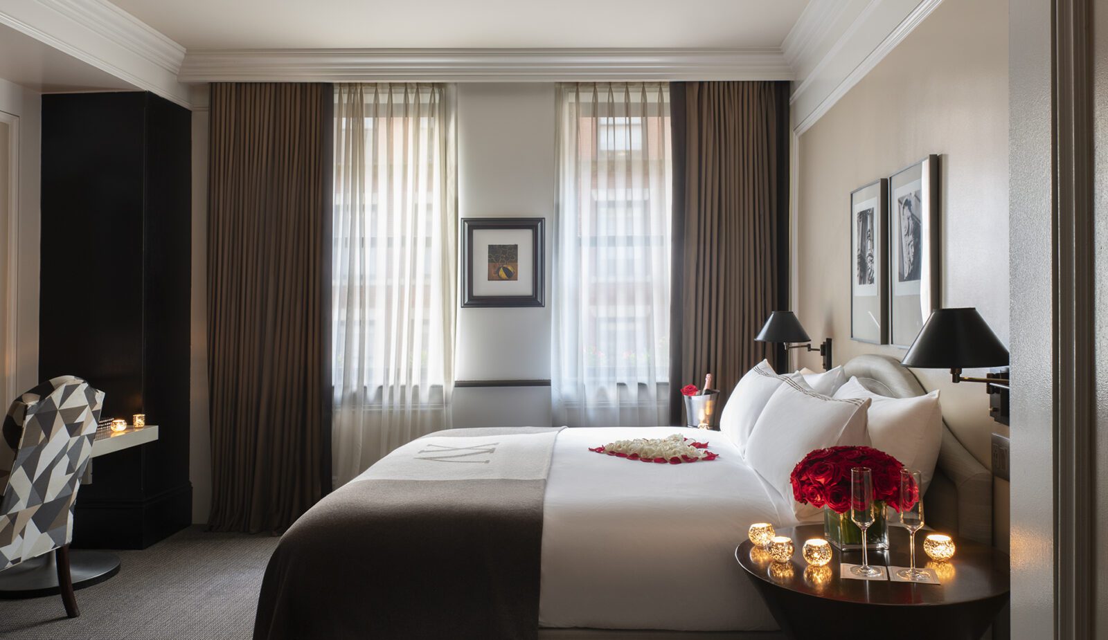 romantic room set up with rose petals on the hotel king size bed