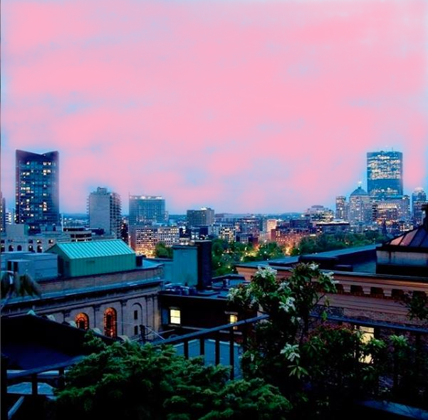 night view from the hotel's roof deck with a pink painted sky for breast cancer awareness month