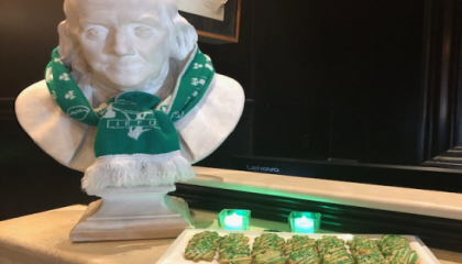 st patricks day photo of hotel with green scarf on Ben Franklin statue