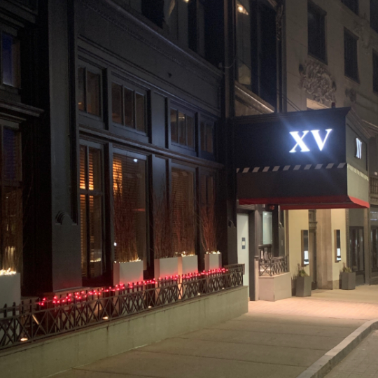 photo of the xv beacon hotel at night with red lights lite