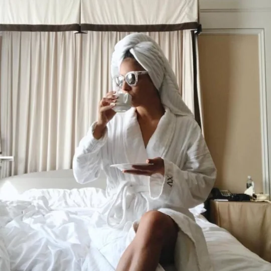 woman on XV Beacon Bed with our custom Frette Robes