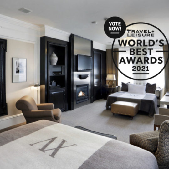 Photo of the Boston Common Studio guestroom within XV Beacon with a Vote Now Logo for the Travel and Leisure World's Best Awards