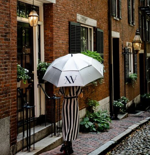 woman walking on acorn street with an XV Beacon Umbrella