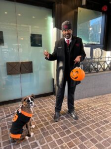 Dog Dressed up in a Halloween Sweater out front of the XV Beacon Hotel