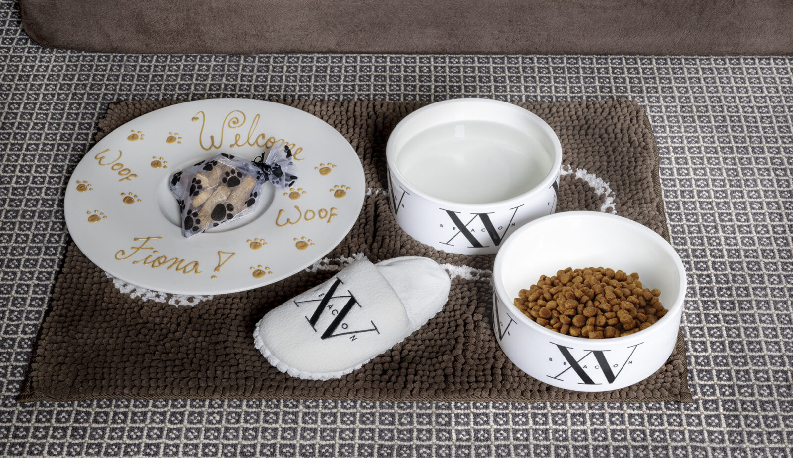 photo of our dog amenity with dog treats and a plush dog chew toy slipper