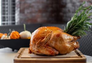 Thanksgiving Turkey with a pumpkin display in the background